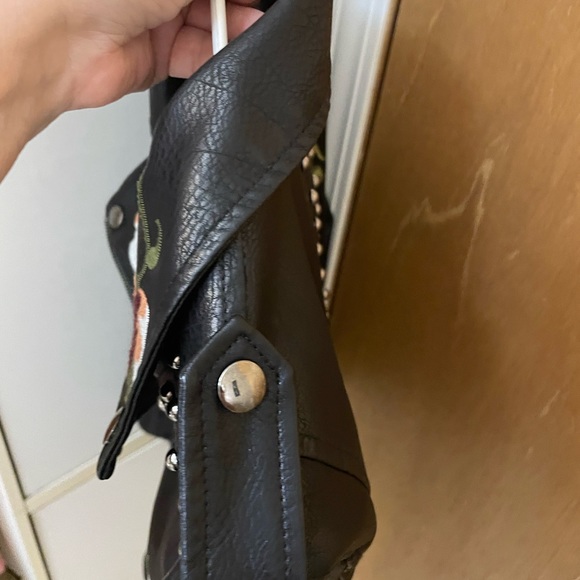 Floral embroidery, stud accents, buckles on side, faux leather, zipper on arms. - Picture 6 of 8